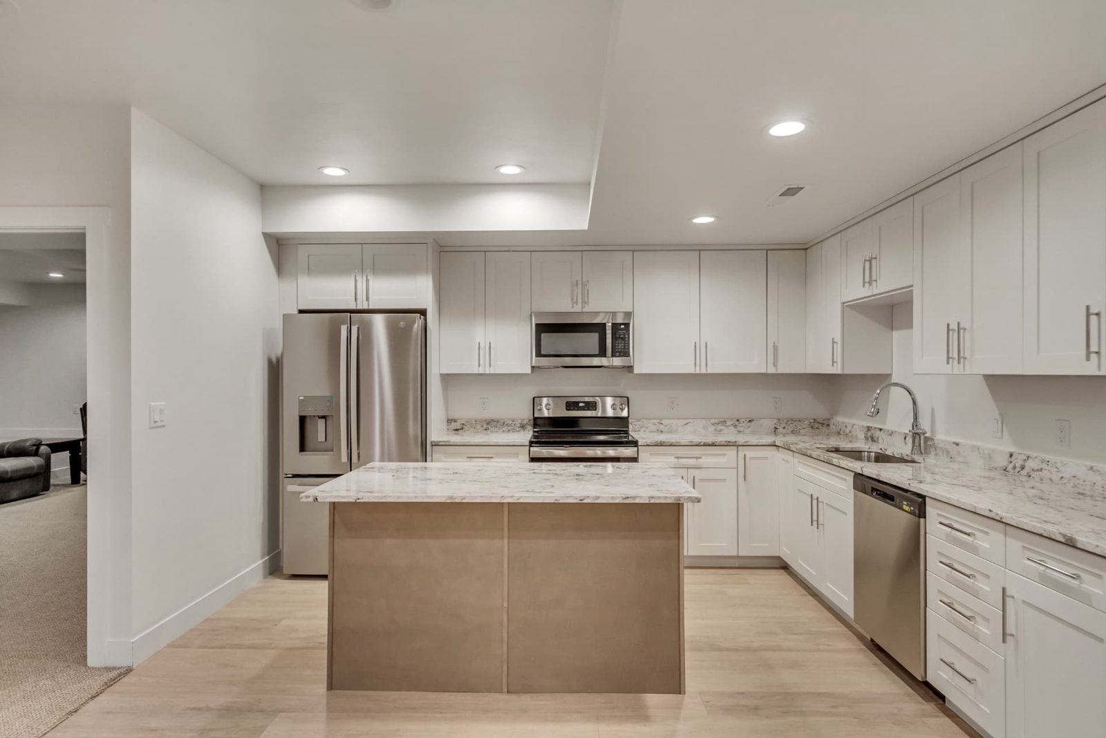 Bright granny flat living space with kitchenette designed for aging in place