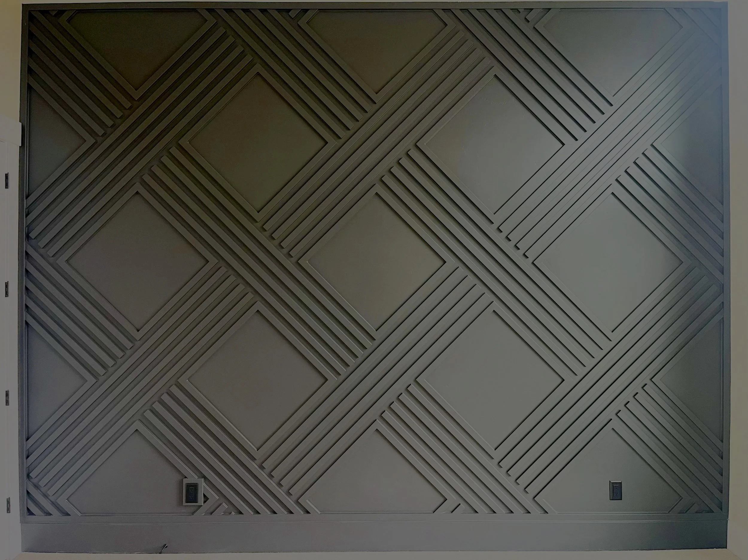 Geometric custom millwork accent wall built by Outlook Builders
